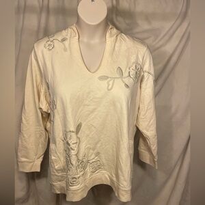 Avenue size 26/28 cream colored embroidered hoodie with side slash pockets.